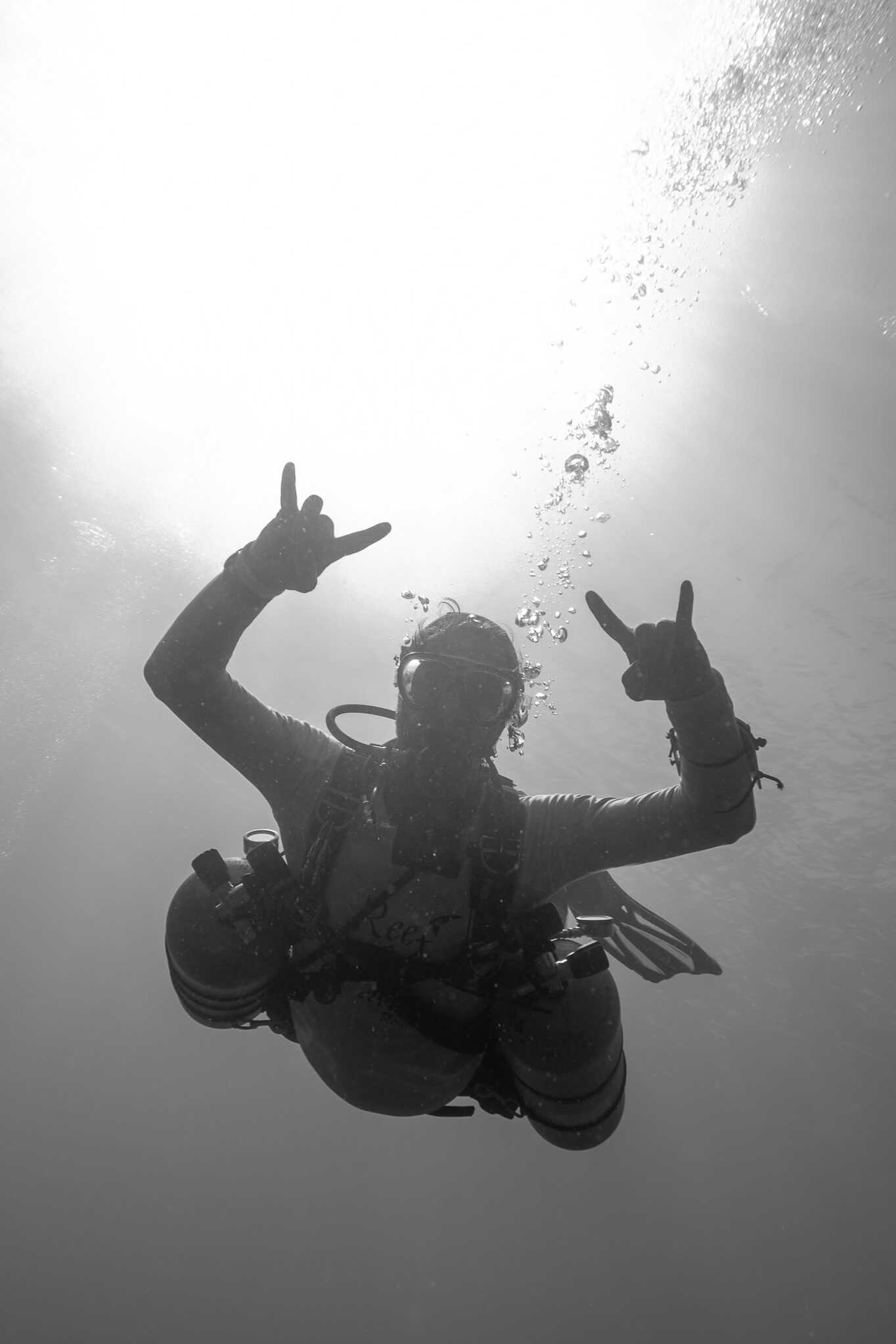 Diver waving hands underwater