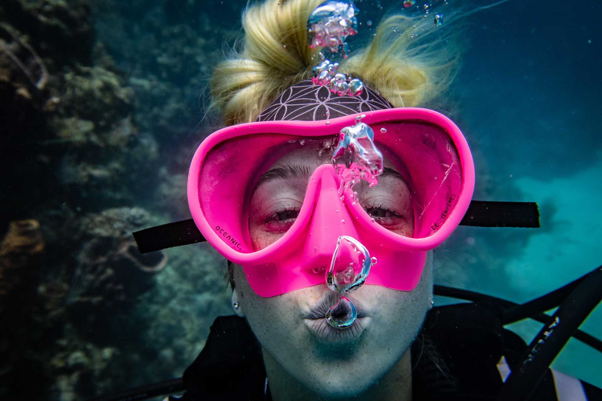 Diver underwater blowing bubbles