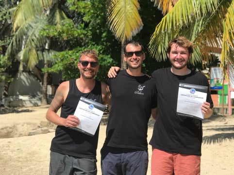 Two instructor graduates collecting their certificates